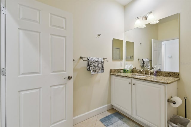 bathroom with tile patterned flooring, vanity, and baseboards