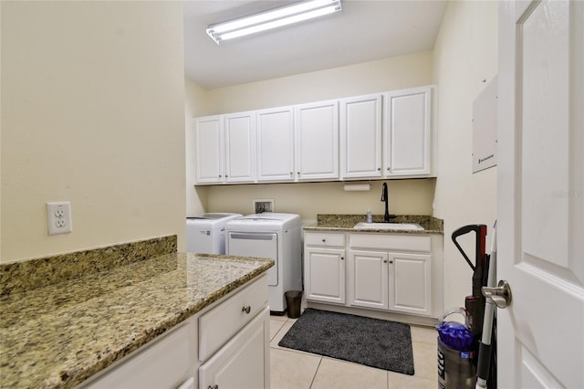 laundry area with light tile patterned flooring, cabinet space, washer and dryer, and a sink