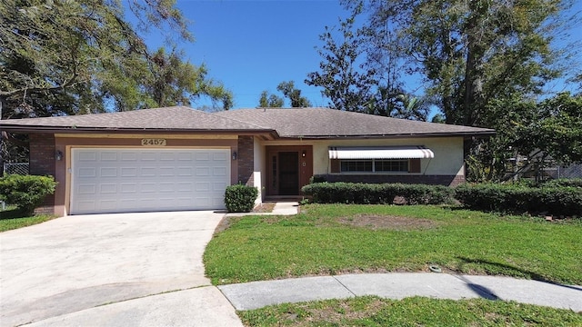 single story home with stucco siding, concrete driveway, a front lawn, and a garage