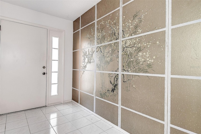 foyer with tile patterned flooring and a healthy amount of sunlight