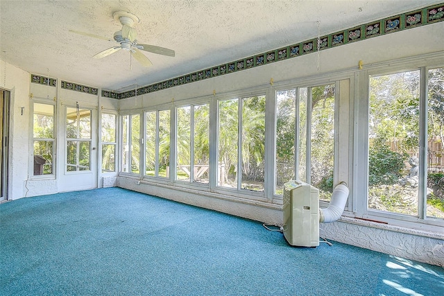 unfurnished sunroom featuring plenty of natural light and ceiling fan