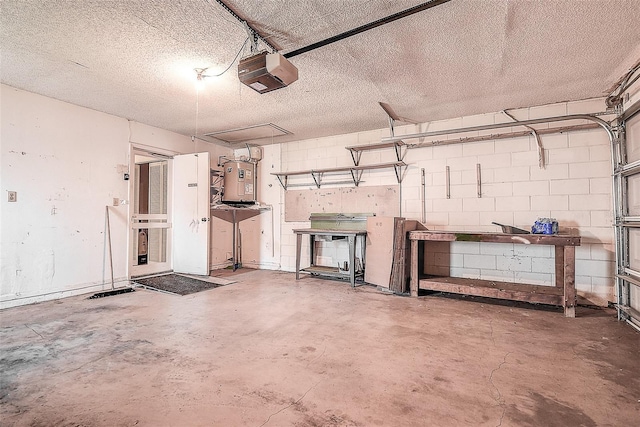 garage with water heater, concrete block wall, and a garage door opener