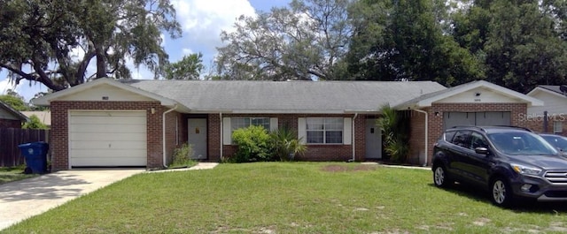 ranch-style house featuring driveway, brick siding, an attached garage, and a front yard