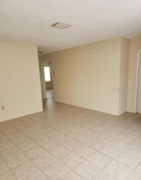 spare room with visible vents and a textured ceiling