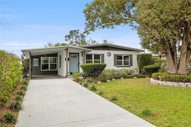 view of front of home featuring concrete driveway, a front yard, and stucco siding