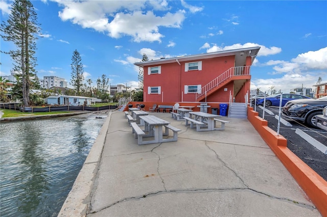 exterior space featuring a water view and stairs