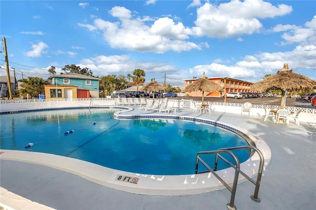 community pool featuring a patio area and fence