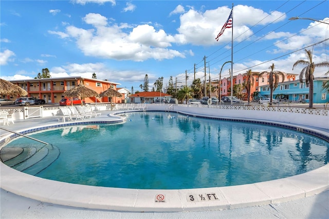 community pool featuring a residential view and fence