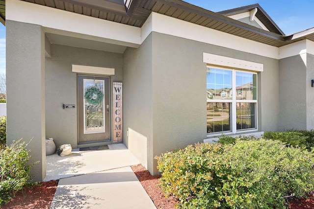 doorway to property with stucco siding