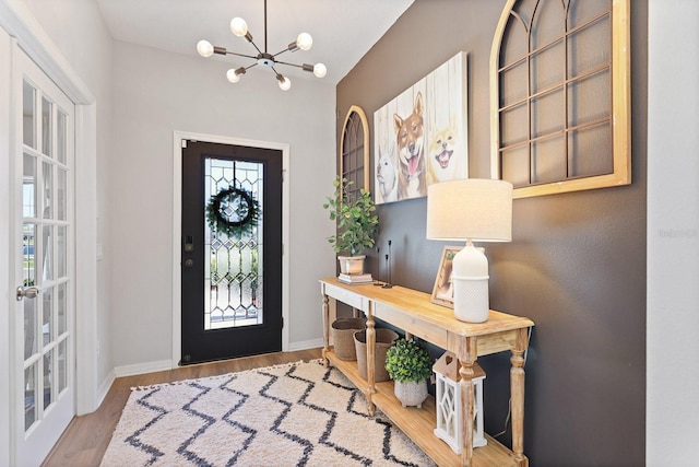 entryway with baseboards, wood finished floors, and a healthy amount of sunlight