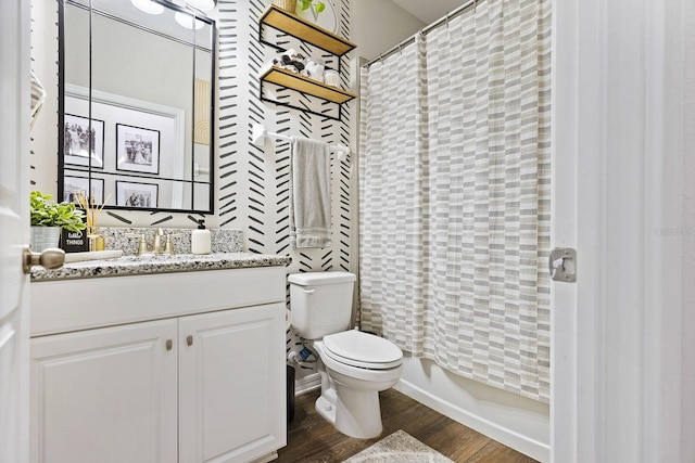 bathroom featuring a shower with shower curtain, vanity, toilet, and wood finished floors