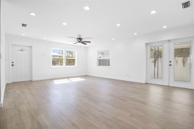 unfurnished living room featuring light wood-style floors, visible vents, and recessed lighting