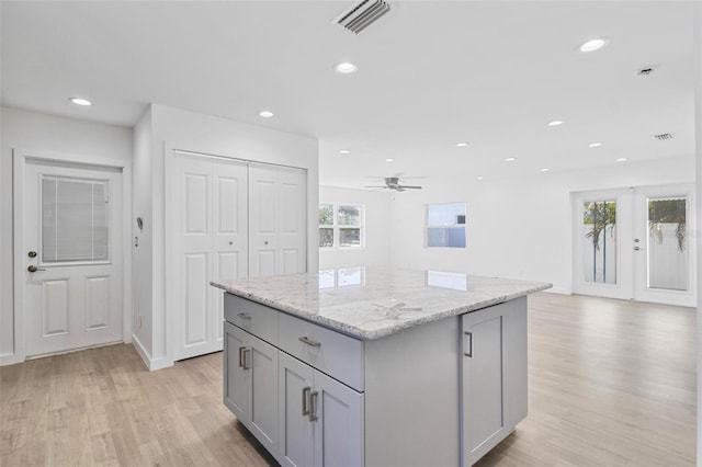 kitchen featuring recessed lighting, a center island, visible vents, and gray cabinetry