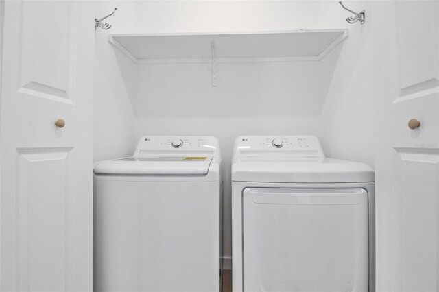 clothes washing area with laundry area and washing machine and clothes dryer