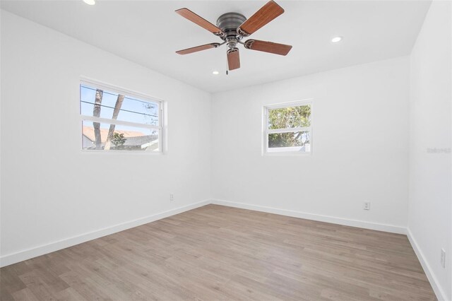 unfurnished room with light wood-type flooring, ceiling fan, baseboards, and recessed lighting