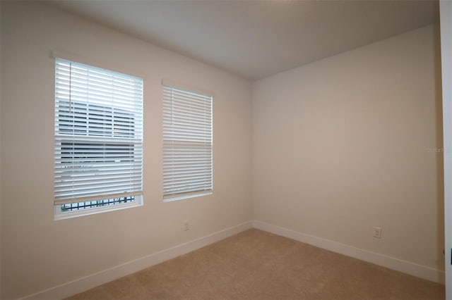 spare room with carpet flooring and baseboards