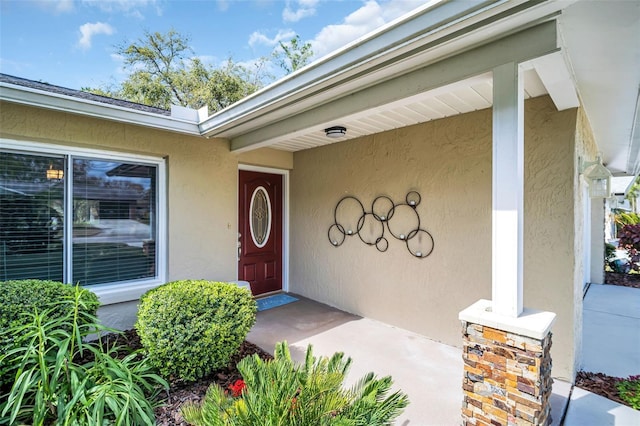 entrance to property featuring stucco siding