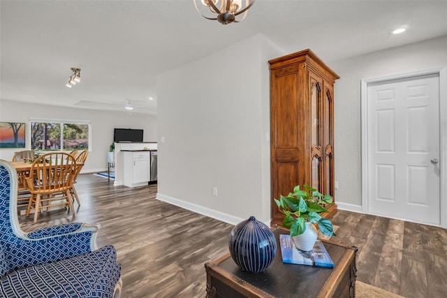 living room with dark wood-type flooring, recessed lighting, and baseboards