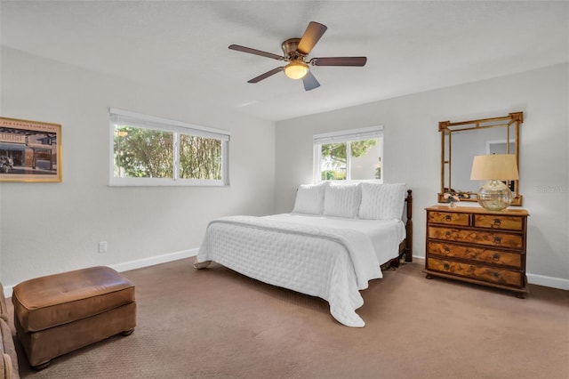 carpeted bedroom with ceiling fan and baseboards