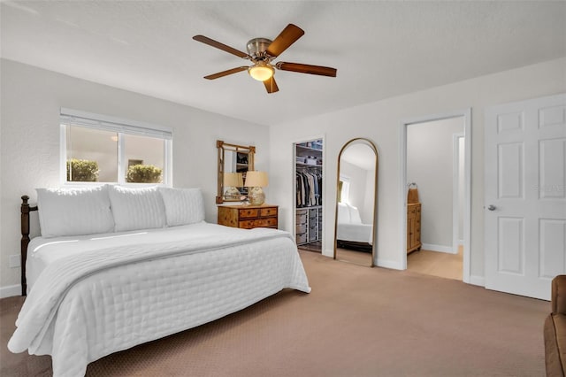 bedroom with light carpet, baseboards, and a ceiling fan