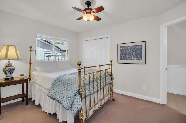 carpeted bedroom with a closet, ceiling fan, and baseboards