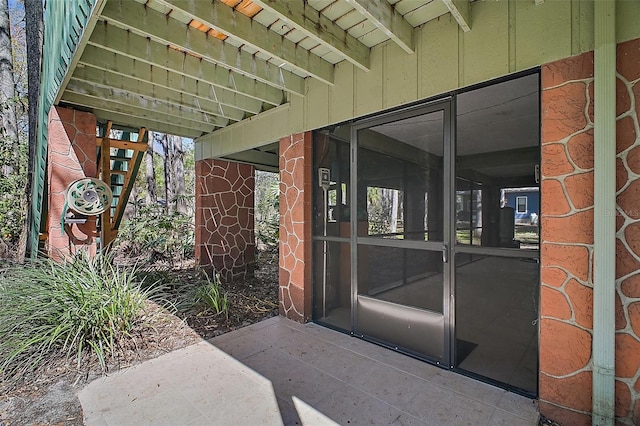 entrance to property featuring brick siding