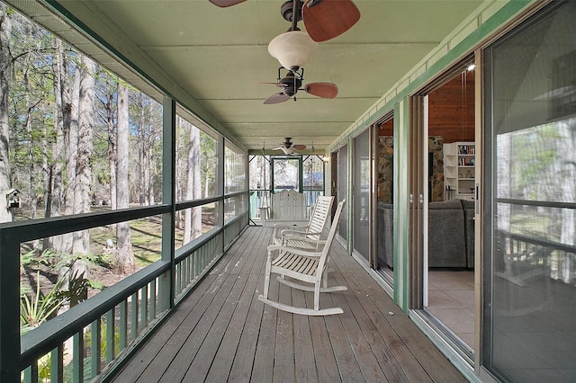 unfurnished sunroom with ceiling fan