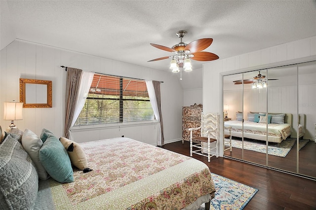 bedroom with a textured ceiling, ceiling fan, a closet, and wood finished floors