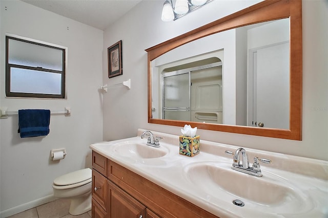 full bathroom featuring tile patterned flooring, a sink, a shower stall, and toilet