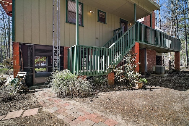 view of side of property with stairs and cooling unit