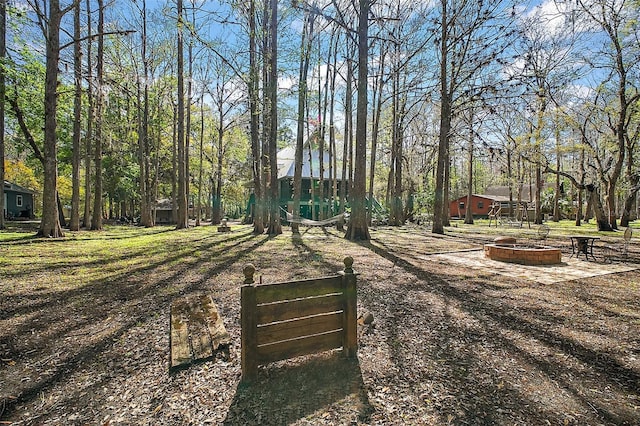 surrounding community featuring a fire pit