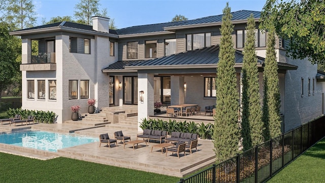 rear view of house with metal roof, a patio, fence, an outdoor living space, and a standing seam roof