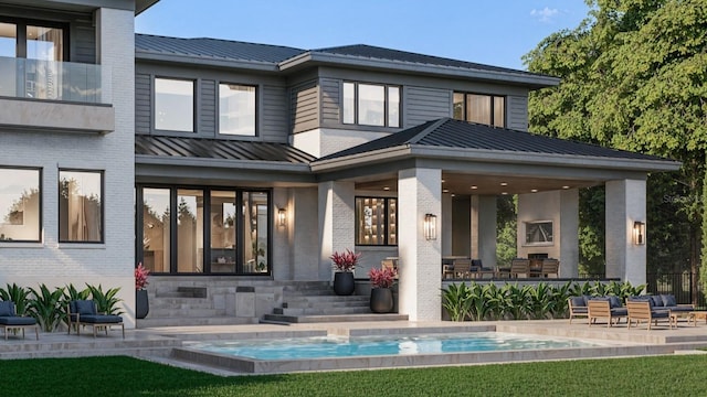 back of property with brick siding, a patio, a standing seam roof, metal roof, and an outdoor pool