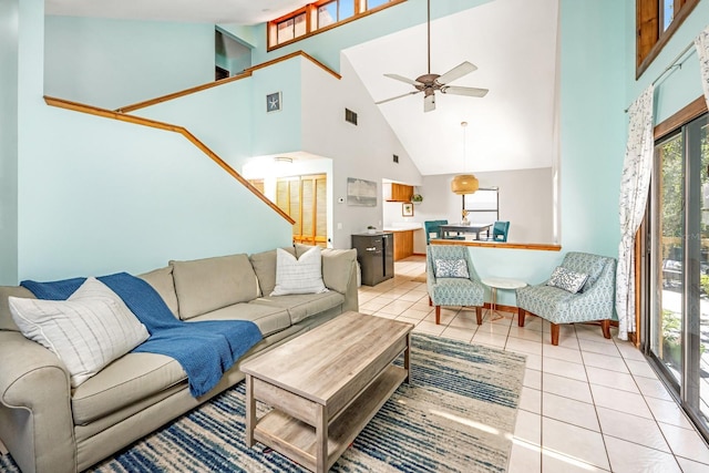 living area with visible vents, a high ceiling, light tile patterned flooring, and a ceiling fan