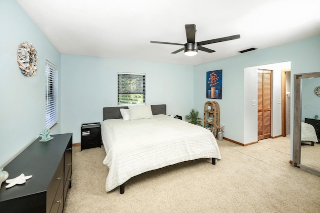 bedroom with ceiling fan, baseboards, visible vents, and light carpet