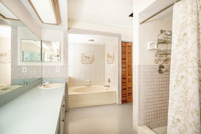full bathroom featuring a garden tub, vanity, tile walls, and a shower stall