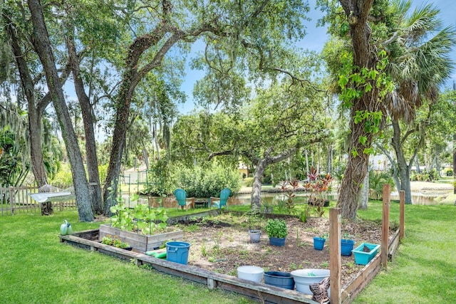 view of yard featuring a vegetable garden and fence