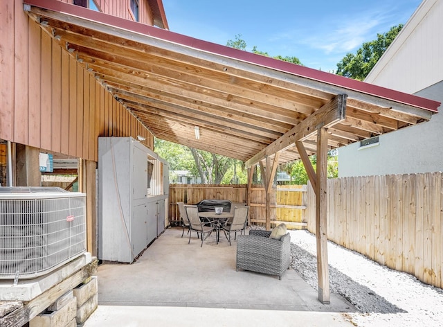 view of patio featuring central air condition unit and outdoor dining area
