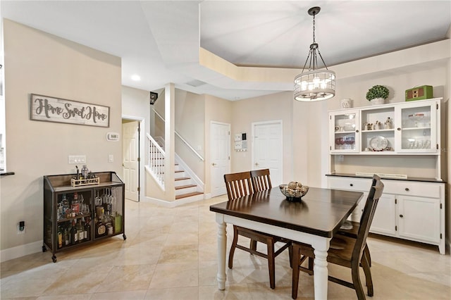 dining room with baseboards, stairway, a tray ceiling, a notable chandelier, and light tile patterned flooring