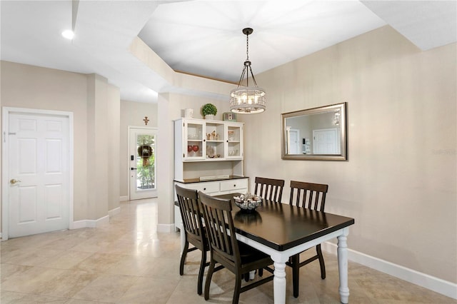 dining room with baseboards and a notable chandelier