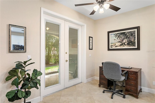 tiled home office featuring ceiling fan, baseboards, and french doors