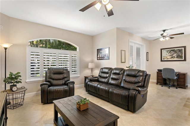 living room featuring light tile patterned flooring, a ceiling fan, and baseboards