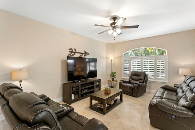 living area with ceiling fan, light tile patterned floors, and baseboards