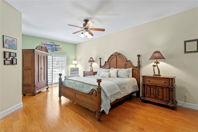 bedroom with a ceiling fan, light wood-style flooring, and baseboards