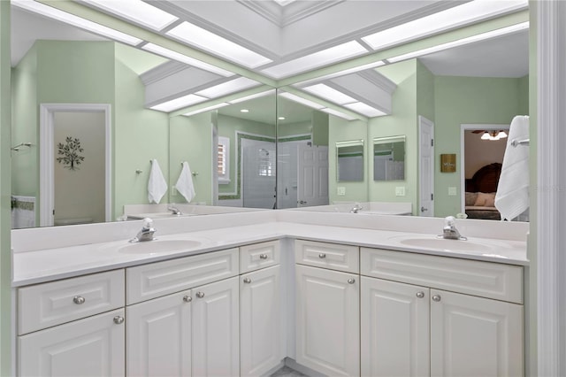 full bathroom featuring double vanity, a sink, and ensuite bathroom