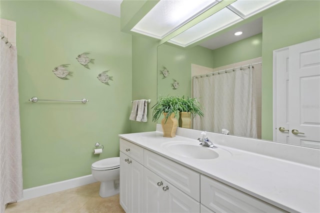 bathroom featuring toilet, vanity, baseboards, and tile patterned floors