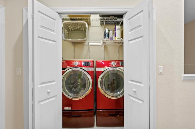 clothes washing area featuring laundry area and washer and clothes dryer