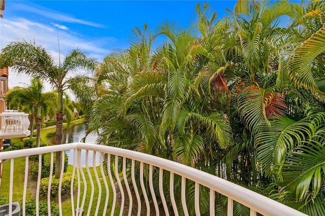 balcony featuring central AC and a water view