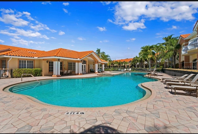 community pool featuring a patio area