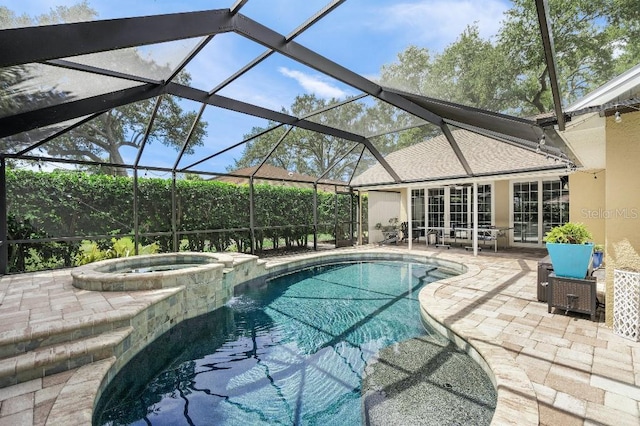 view of swimming pool featuring a lanai, a patio area, and a pool with connected hot tub